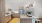 Model kitchen at our apartments in Mansfield, featuring wood grain floor paneling and a kitchen island with a sink.