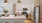 Model kitchen at our apartments in Mansfield, featuring wood grain floor paneling and a kitchen island with a sink.